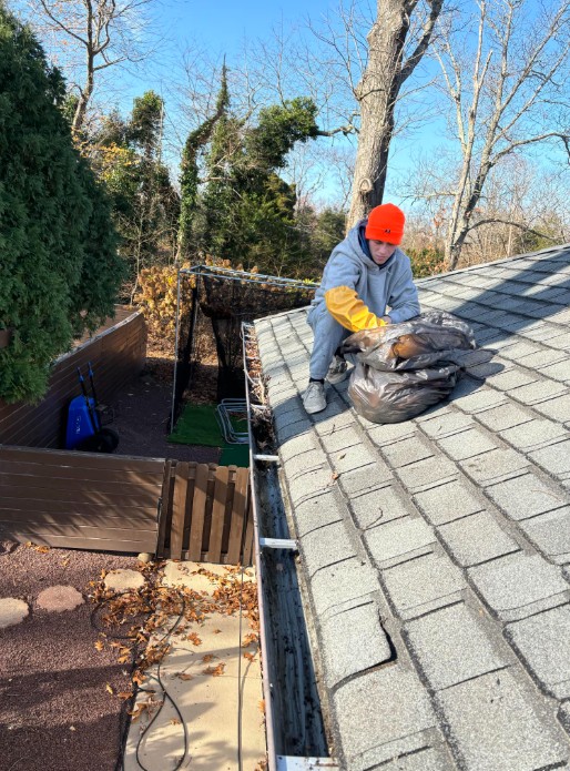 gutter cleaning service new jersey helps clean gutters filled with autumn leaves and pine needles on New Jersey homes